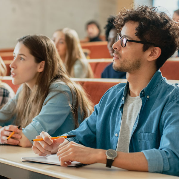 Male and female university students in lecture theatre