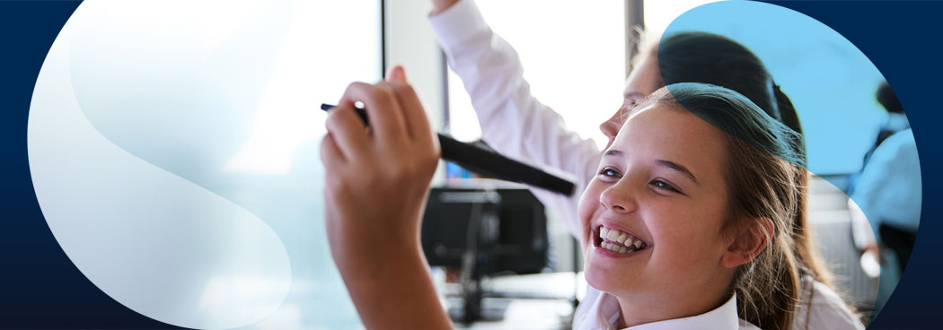 Female school student writing on digital whiteboard